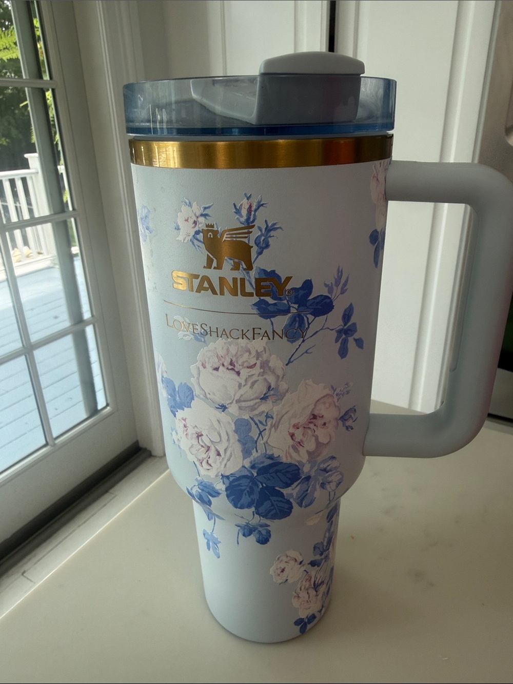 Stanley White Travel Tumbler with Blue Floral Pattern and Gold Logo